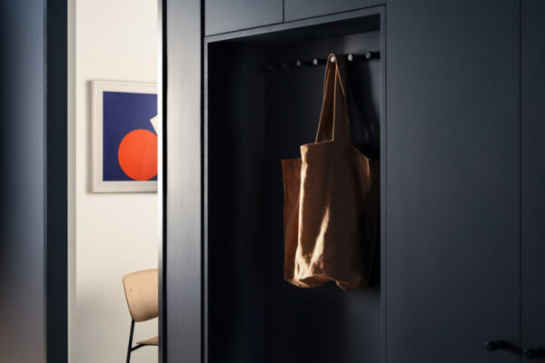 Dark built-in joinery with integrated coat storage in the Milanote Melbourne office fitout, showcasing refined workspace detailing and functional interior design.