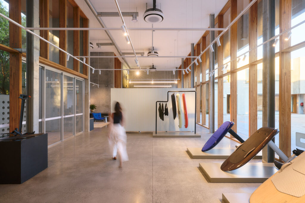 Fliteboard Office Fitout in Byron Bay, featuring polished concrete floors, timber-framed glazing, display plinths and refined industrial detailing.
