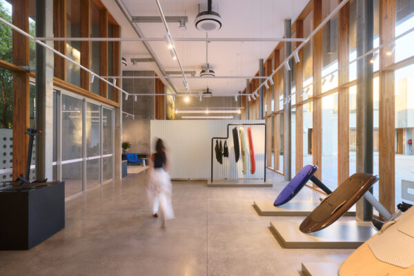 Fliteboard Office Fitout in Byron Bay, featuring polished concrete floors, timber-framed glazing, display plinths and refined industrial detailing.