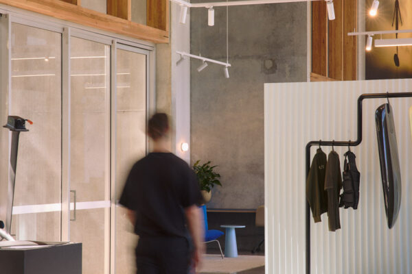 Fliteboard Office Fitout in Byron Bay, featuring polished concrete floors, timber detailing, display fixtures and industrial-style lighting.